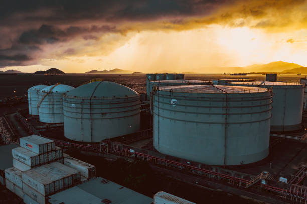 oil tanker and oil tank in port at night - oil storage tank storage compartment fuel and power generation imagens e fotografias de stock