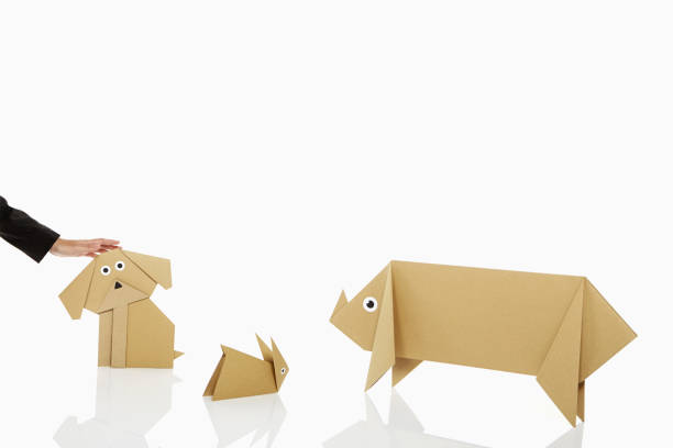istock Human hand petting a paper dog 1263761508