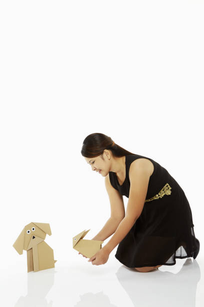 istock Woman holding up a paper rabbit 1263763543
