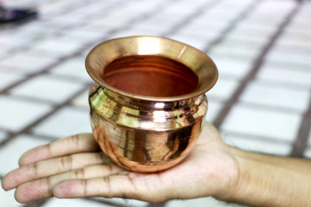 istock The Indian copper shining bowl on a person's hand 1263763612