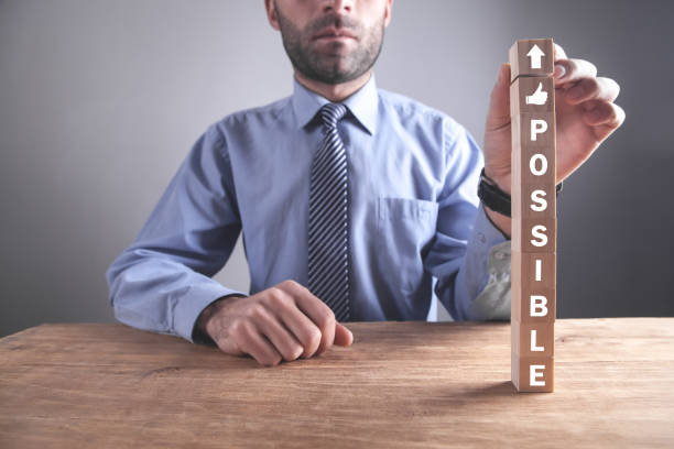 istock Man showing Possible word on wooden cubes. 1263764304