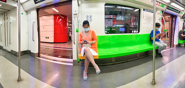 August 04, 2020: Passengers in the Beijing Subway. Use mobile phone, work, play and learn during free time.
