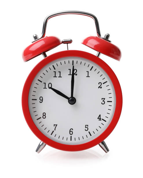 Red alarm clock set at ten isolated over white background Red alarm clock set at ten isolated over white background close-up with clipping path alarm clock stock pictures, royalty-free photos & images