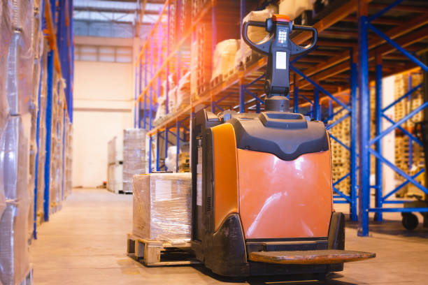 istock Storehouse area, Shipment. Electric forklift pallet jack unloading pallet goods in warehouse storage. 1263770375