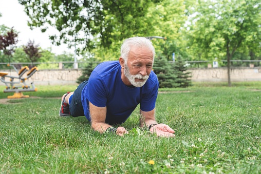 Man doing plank exercise at park
