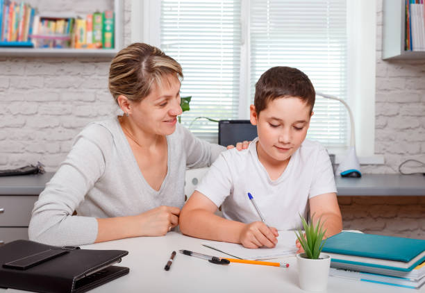 istock Mother and son working on remote project together at home. Quarantine 1263770764