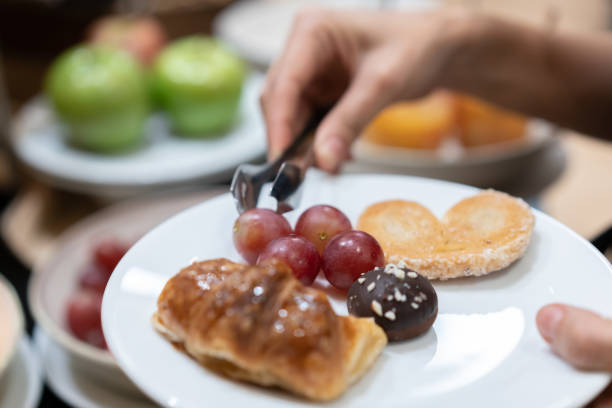 istock Female guest is serving herself at breakfast 1263773645