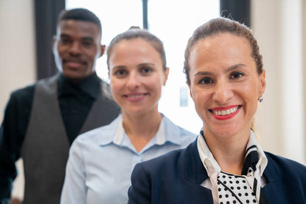 istock Portrait of multi-racial hotel staff smiling. 1263776068