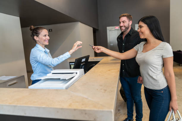 istock Guest giving keycard back to receptionist at hotel front desk from checkout 1263776069