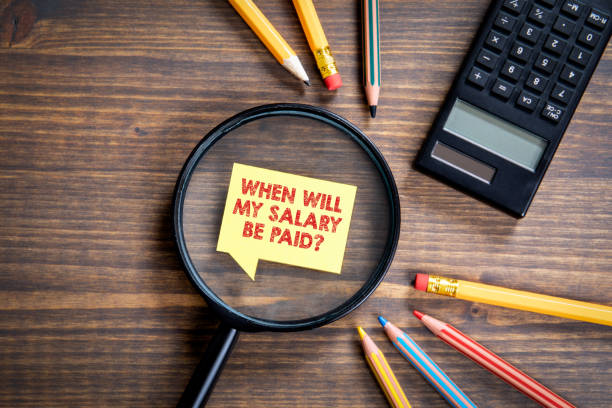 istock WHEN WILL MY SALARY BE PAID? Payday, work and financial difficulties concept. Pencils and calculator 1263776074
