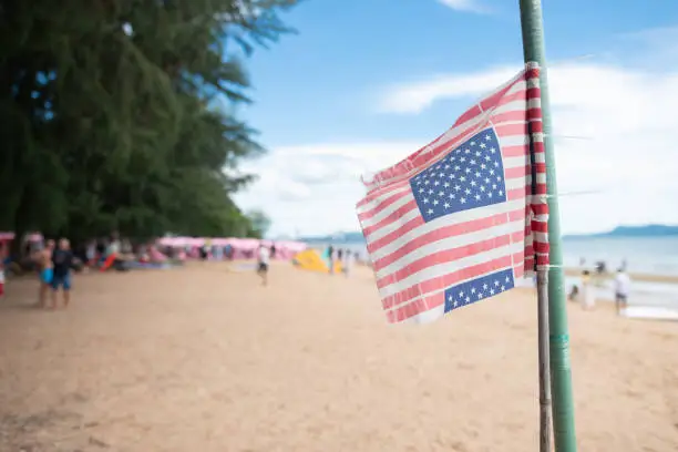 American Flag flying at the Beach,sea sand sky