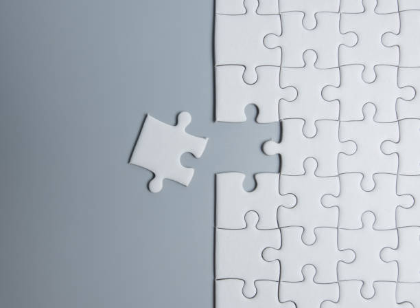 istock The final piece to the jigsaw puzzle success on grey background 1263778989