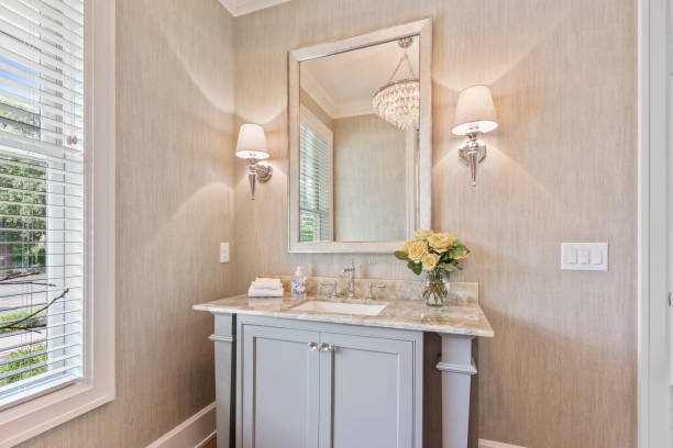 Decorative vanity sink and mirror Wall sconce on each side of mirror in lovely powder room vanity mirror stock pictures, royalty-free photos & images