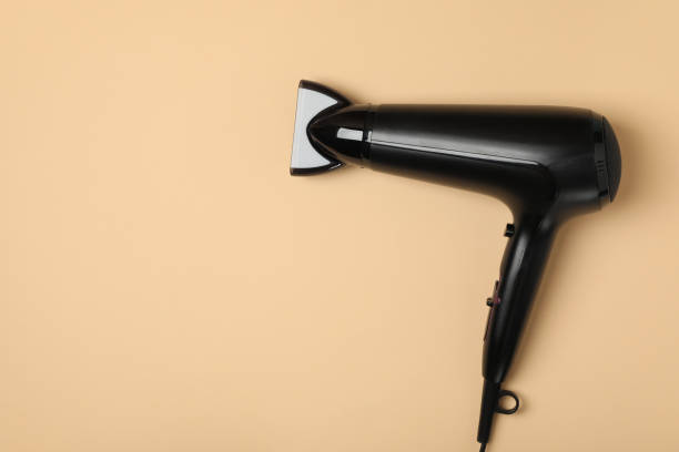 istock Black hair dryer on beige background, space for text 1263781447