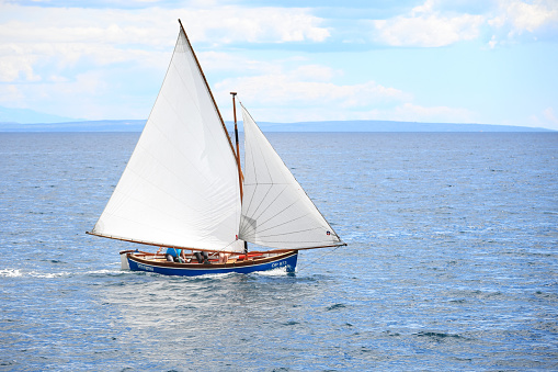 Opatija, Сroatia - July 18, 2020: Classic wooden sailboat in Opatija, Croatia
