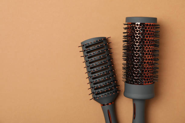 istock Hair brushes on brown background, space for text 1263782442