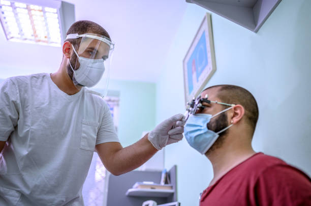Man having his eyes examined by optometrist.