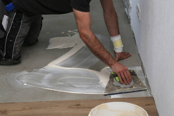 istock The worker installing new vinyl tile floor 1263784070