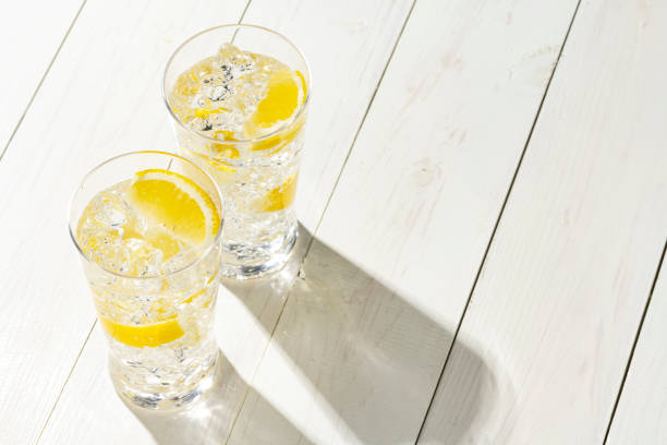 Highball Laced With Lemon juice Flavour. Fresh white plank background. Highball Laced With Lemon juice Flavour. Fresh white plank background. carbonated water photos stock pictures, royalty-free photos & images
