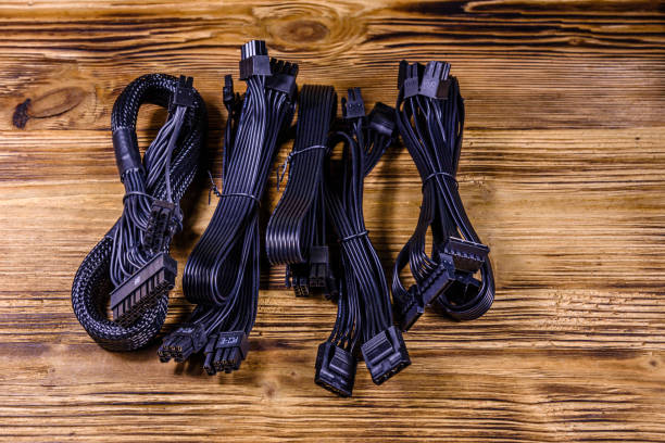 Set of computer psu cables on a wooden background Set of computer psu cables on wooden background connection block computer cable electronics industry electricity stock pictures, royalty-free photos & images