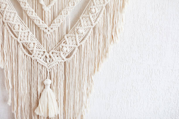 istock Close-up of hand made macrame texture pattern. ECO friendly modern knitting DIY natural decoration concept  in the interior. Flat lay. Handmade macrame 100% cotton. Female hobby. Copy space for text 1263786604