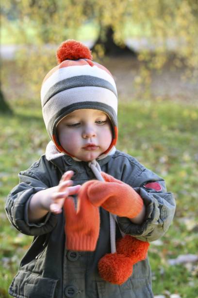 istock Preschooler putting on mittens by himself 1263787354