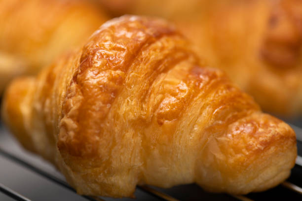 istock Freshly baked croissant in the oven 1263787501