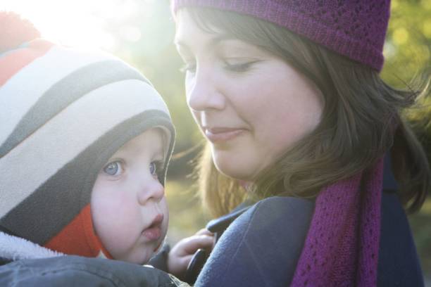 istock Mother carrying son in the park 1263788242