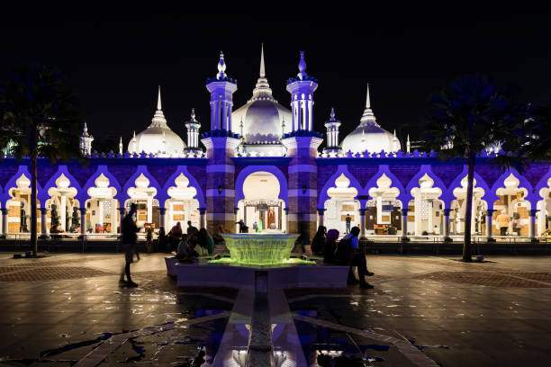 Blue illuminated Mosque Masjid Jamek at night in Kuala Lumpur, Malaysia stock photo