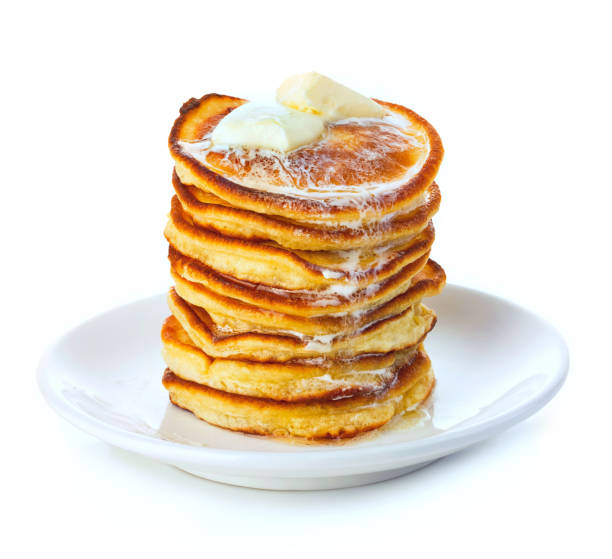 istock Stack of small pancakes in syrup on white background. 1263789544