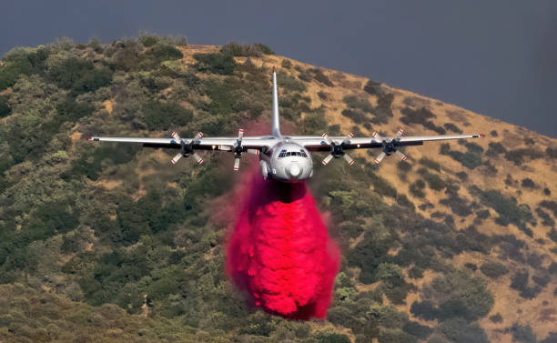 Aircraft Tanker drops fire suppressor Wildfire aircraft drop fire retardant during the Apple Fire in southern California. military tanker airplane photos stock pictures, royalty-free photos & images