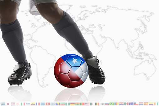 Soccer player dribble a soccer ball with Chile flag