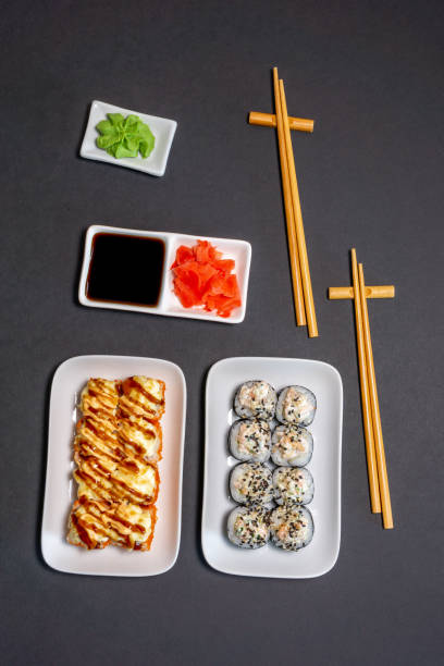 istock japanese sushi roll, ginger, soy sauce, rustic black background, copy space. vertical photo, top view 1263796258