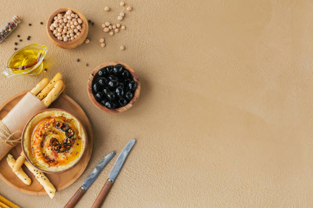Healthy breakfast with homemade hummus, black olives and crispbread.