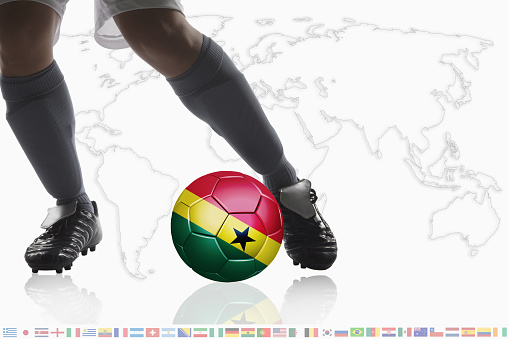 Soccer player dribble a soccer ball with Ghana flag