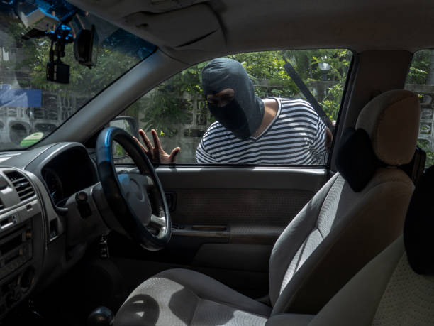 istock Car thief trying to break into a car. 1263818796