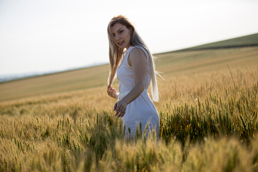 Woman with blonde hair relaxing in the meadow on a sunny day