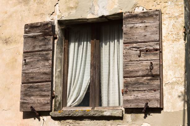 istock Isolated old window with wooden shutters and white curtains (Fiorenzuola di Focara, Pesaro, Italy, Europe) 1263824470