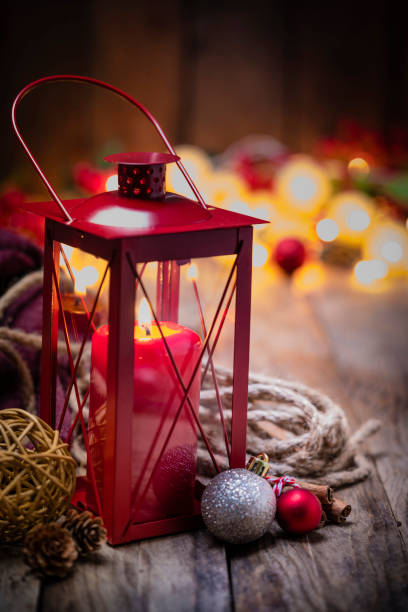 istock Christmas red lantern and ornaments on rustic wooden table. 1263824575