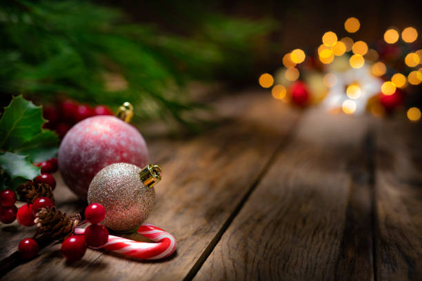 Christmas tree, ornaments and candy on rustic wooden table. Copy space