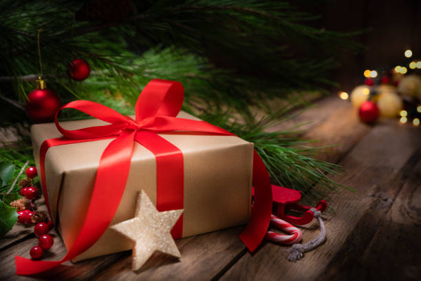 istock Christmas present with ornaments on rustic wooden table. Copy space 1263824712