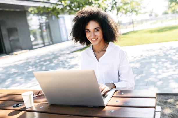istock A woman using a laptop for work outdoors 1263825736