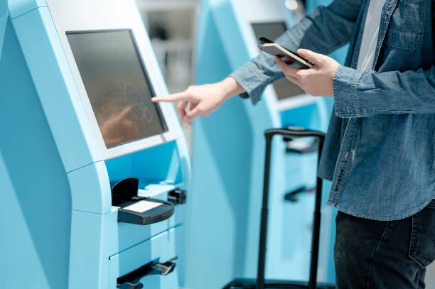 istock Male tourist using self check-in kiosk in airport 1263826251