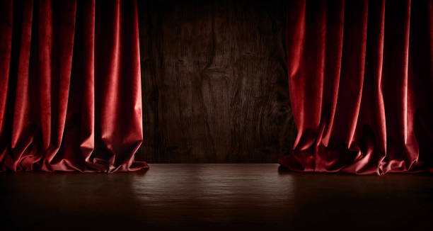 istock Dark stage scene with red curtain 1263829303