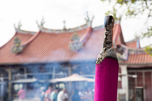 PENANG, MALAYSIA, December 19 2017: Giant pink joss sticks burning at a vintage Buddhist temple courtyard as offering during Chinese New Year in Penang, Malaysia.