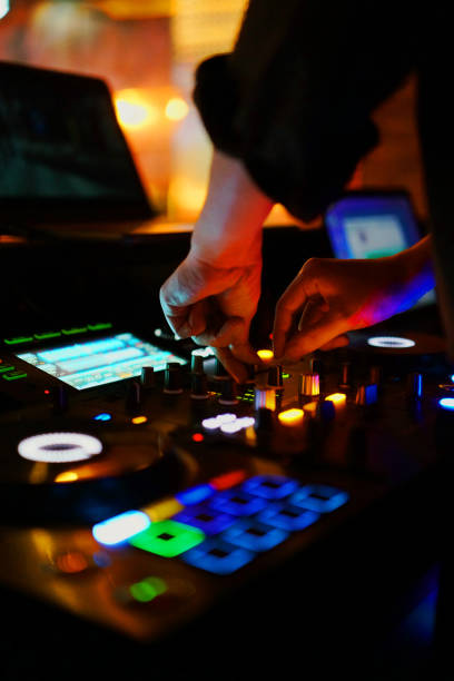 istock Club DJ playing the music mixing control panel 1263831551