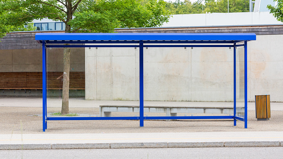 Gauting, Bavaria / Germany - July 22, 2020: View on a bus station. Neutral: no signs, no passengers. Symbol for gone, waiting or leaving.