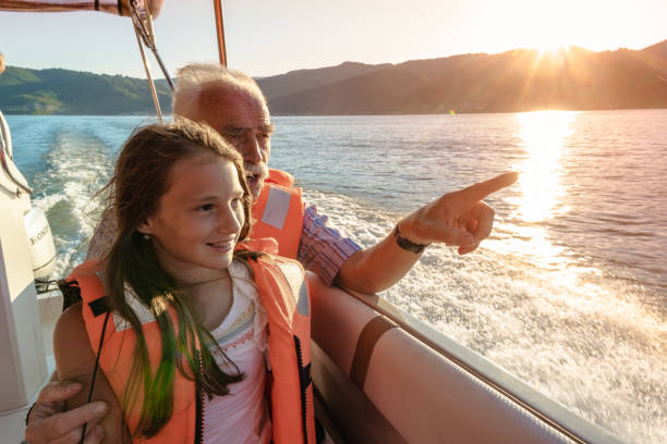 Grandfather with Granddaughter on a boat stock photo