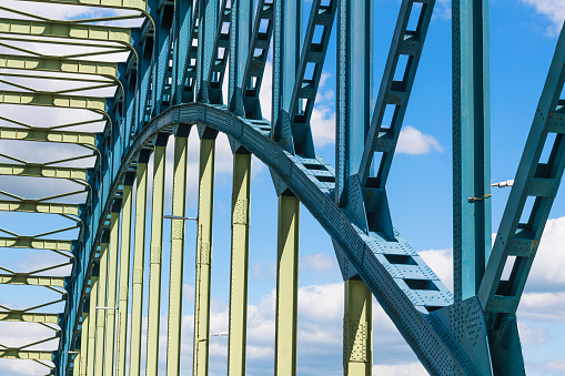 Old IJsselbrug over the river IJssel between Zwolle and Hattem. Upwards view on the construction from the middle of the road on the old steel arch bridge.