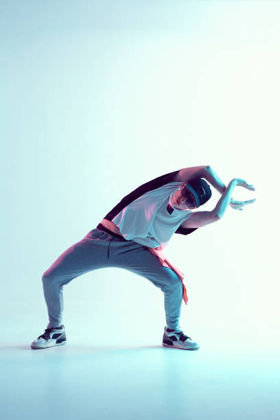 istock Cool young breakdancer guy dance in studio in neon light. Dance school poster 1263835465